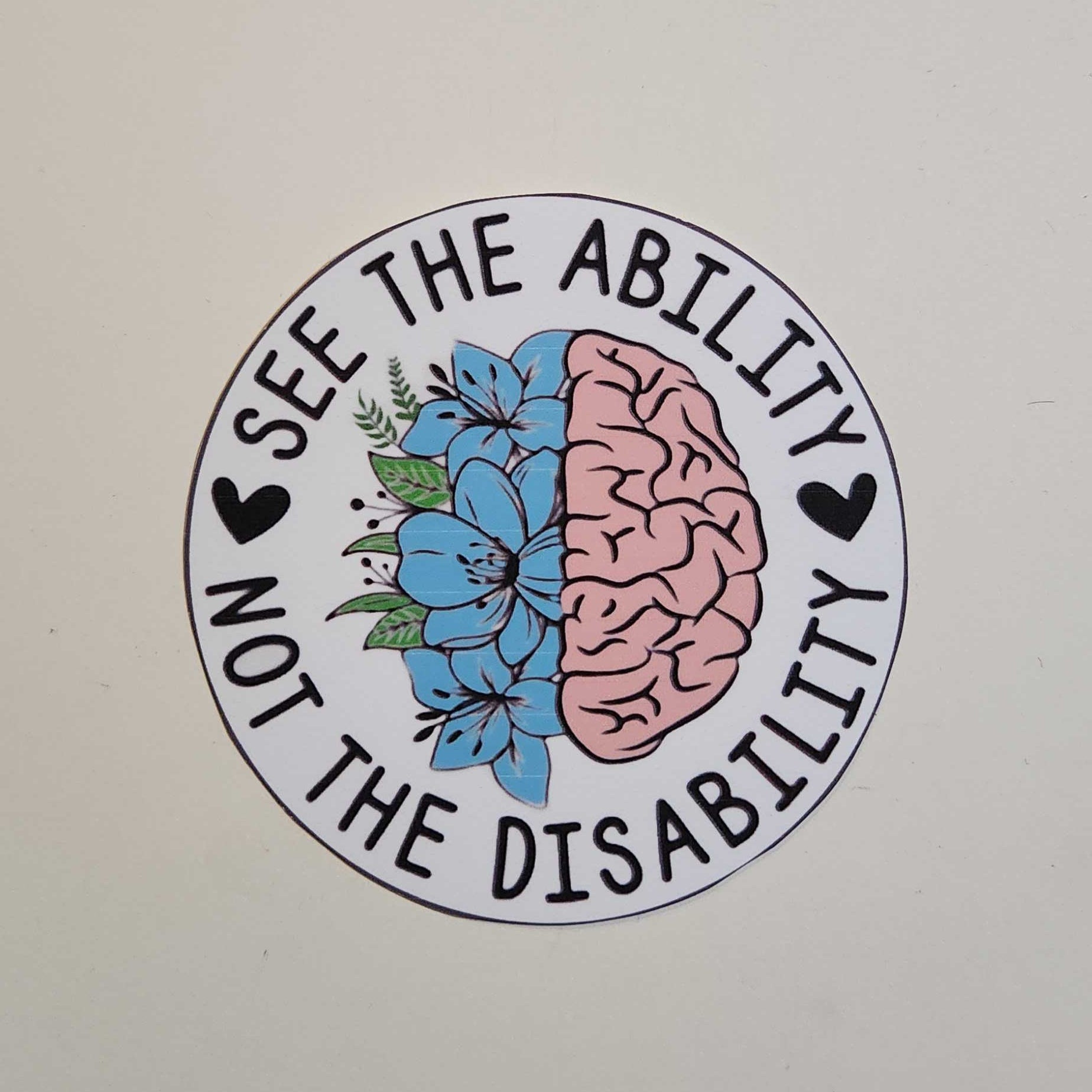 Circular sticker with brain and flowers design on a white background
