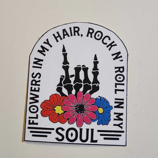 Sticker with skeleton, flowers, and text on a white background