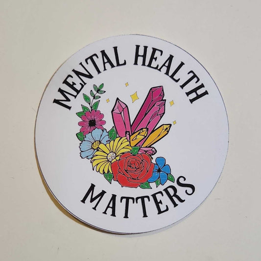 Round sticker with floral design and text 'Mental Health Matters' on a white background