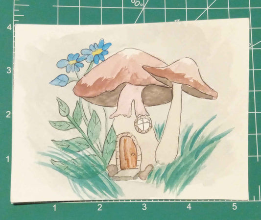 Illustration of a mushroom house with flowers on a cutting mat
