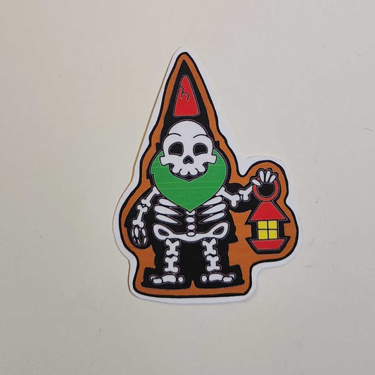 Sticker of a skeleton with a green shirt and red hat on a white surface.