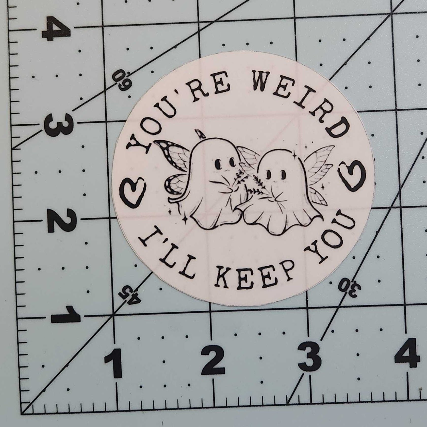 Circular sticker with text and graphics on a grid background
