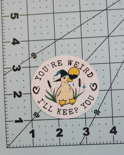 Circular sticker with duck illustration and text on a grid background