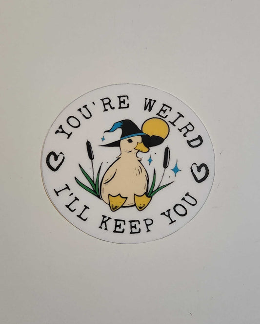 Circular sticker with a duckling design and text on a white background 